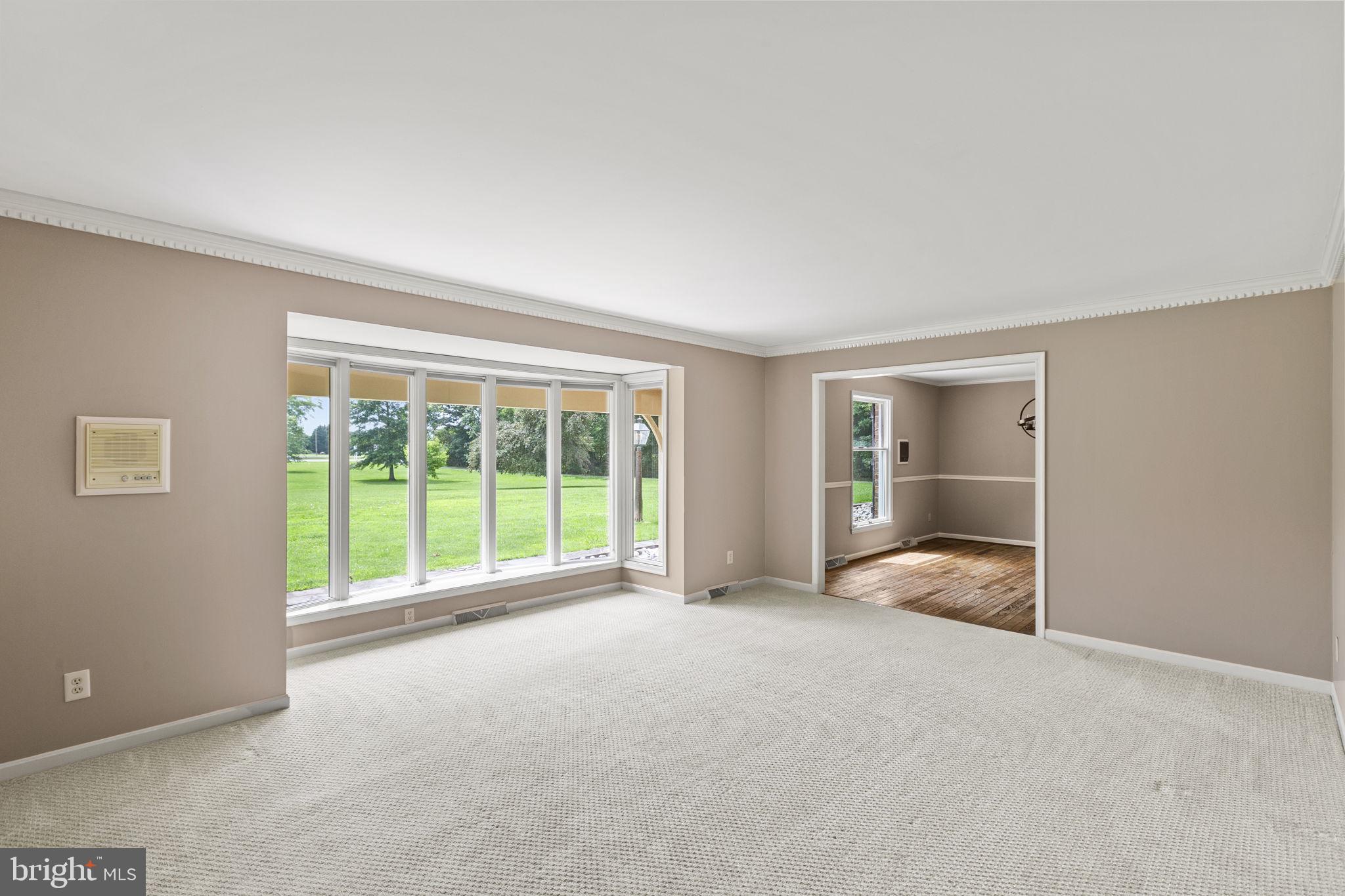 29956 Point Lookout Road Mechanicsville, MD 20659 - Photo 14 of 70 a view of an empty room with a sliding door and wooden floor