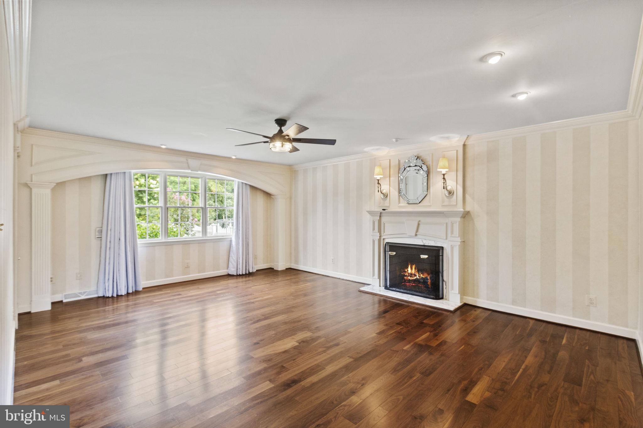 29956 Point Lookout Road Mechanicsville, MD 20659 - Photo 16 of 70 an empty room with wooden floor fireplace and windows