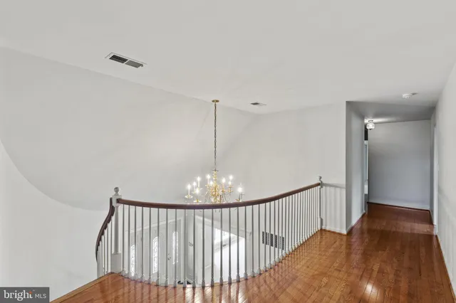 an empty room with closet and windows