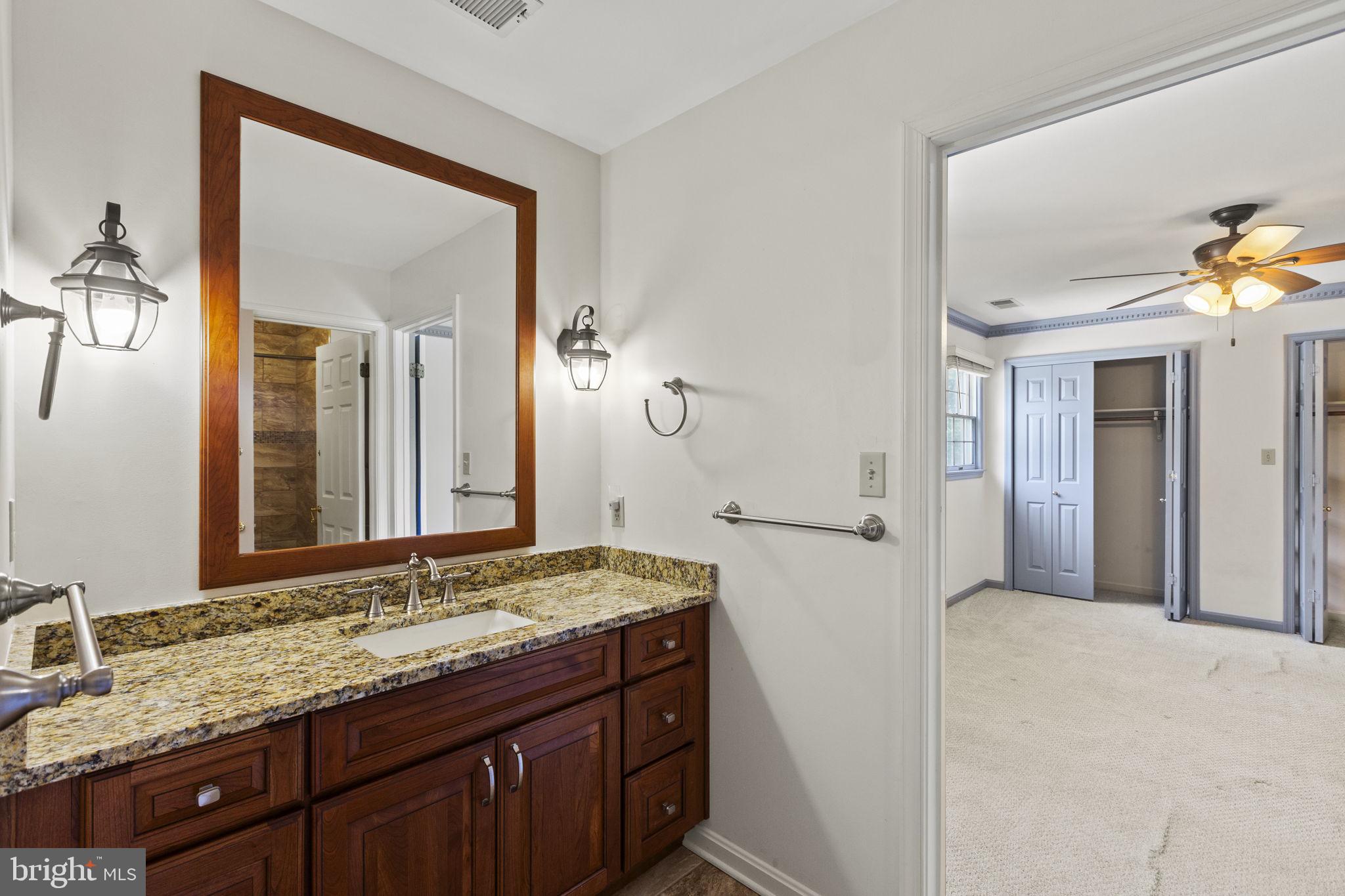 29956 Point Lookout Road Mechanicsville, MD 20659 - Photo 32 of 70 a bathroom with a granite countertop sink and a mirror