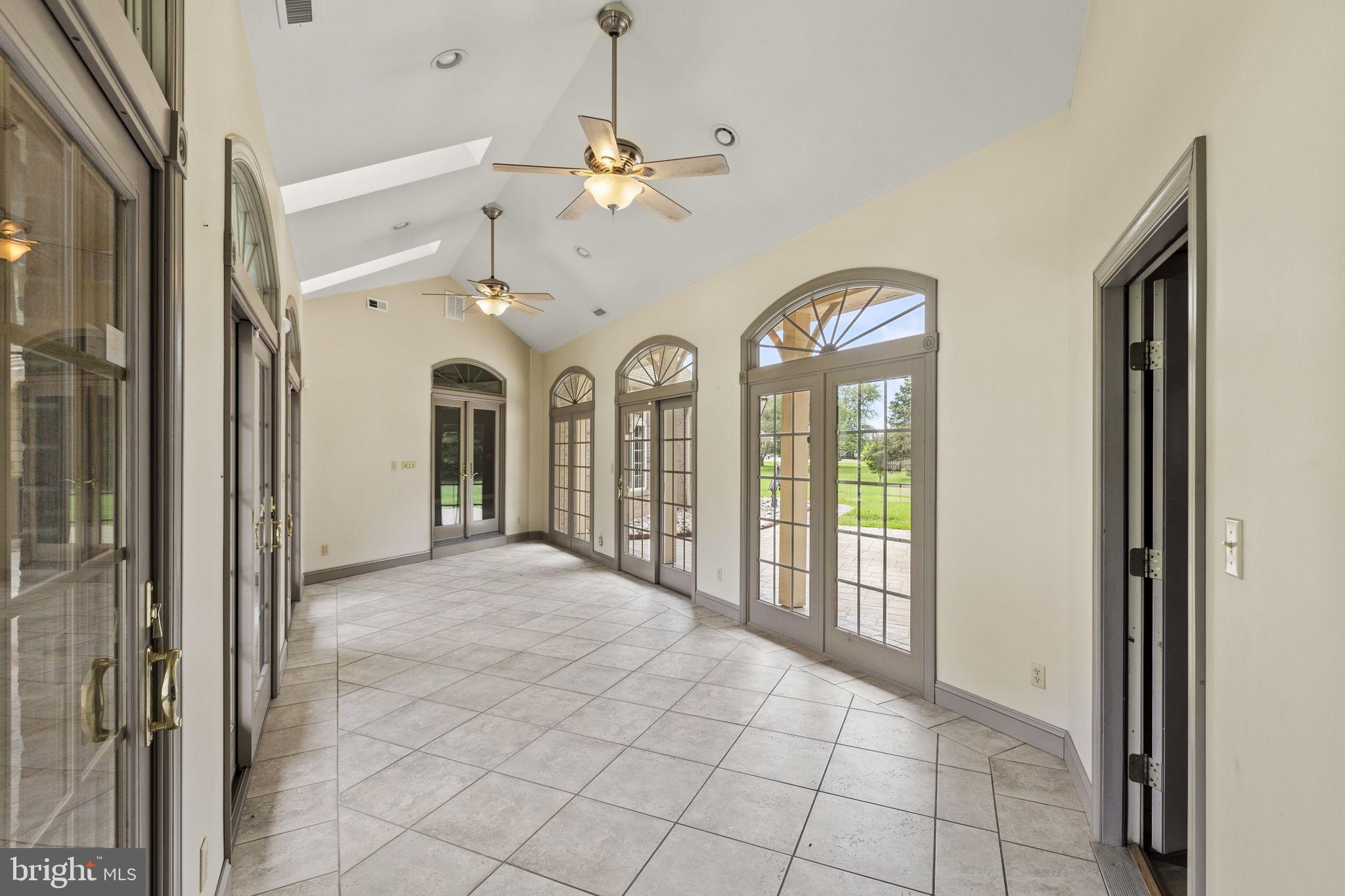 29956 Point Lookout Road Mechanicsville, MD 20659 - Photo 40 of 70 a view of a room with large windows and a chandelier