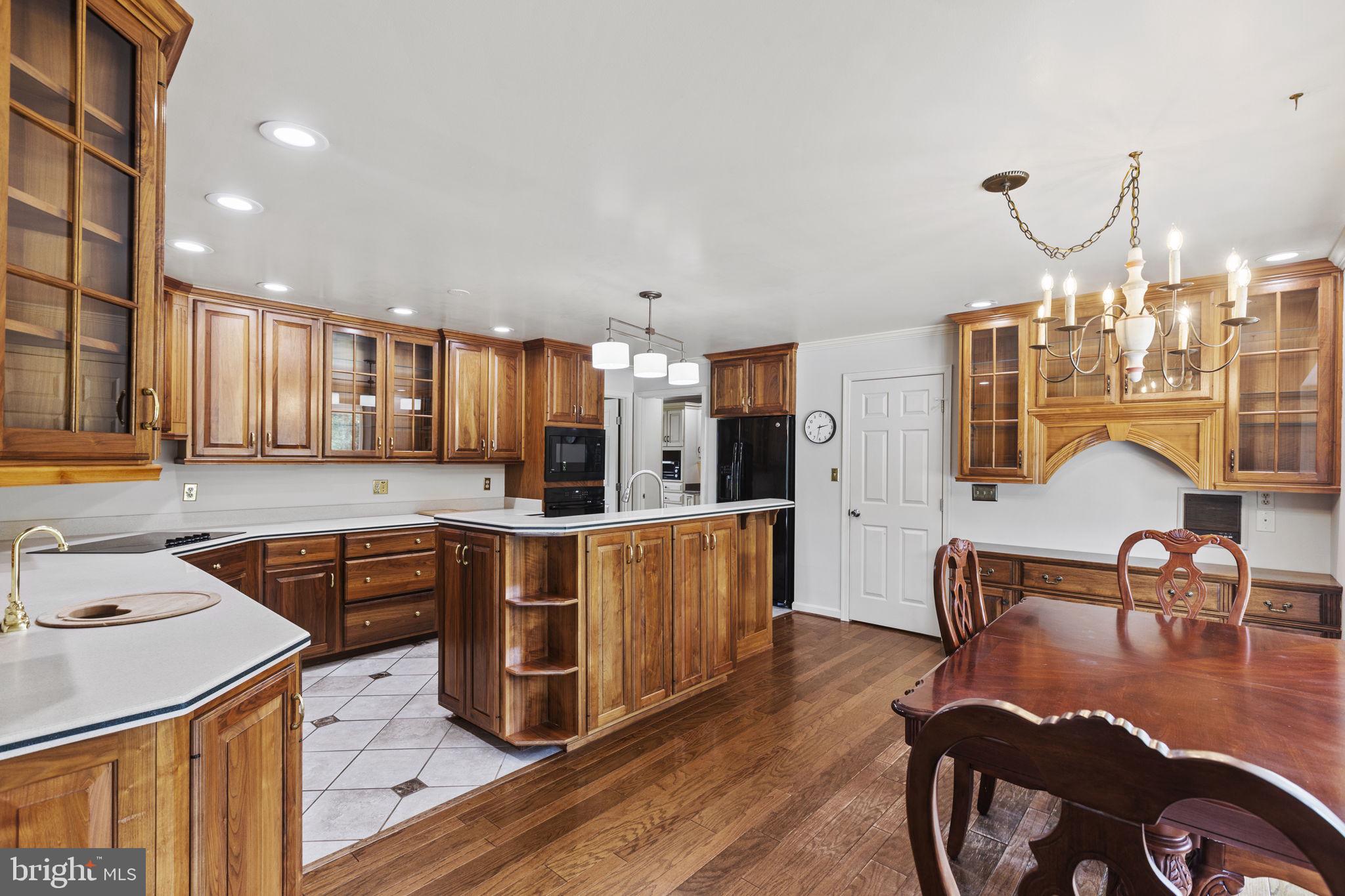 29956 Point Lookout Road Mechanicsville, MD 20659 - Photo 5 of 70 a kitchen with stainless steel appliances granite countertop a refrigerator a stove a sink dishwasher with a dining table and chairs with wooden floor