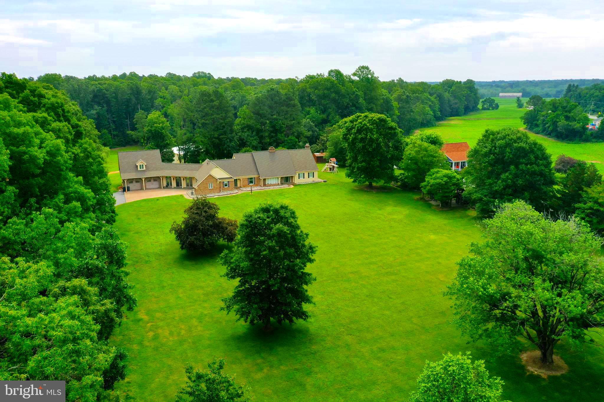 29956 Point Lookout Road Mechanicsville, MD 20659 - Photo 51 of 70 a view of a garden with a building in the background