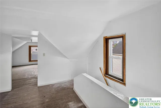 an empty room with windows and cabinet