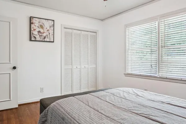 a bedroom with a bed and a window