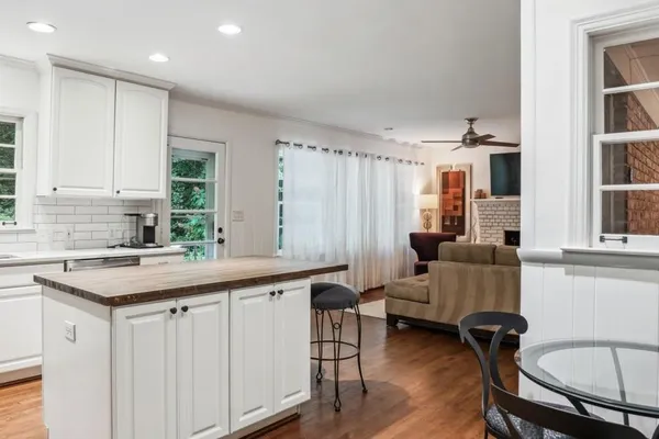 a kitchen with a table chairs sink and cabinets