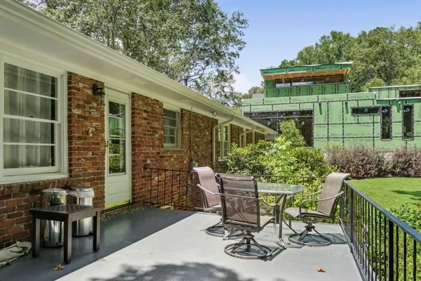 a view of a chair and table in backyard of the house