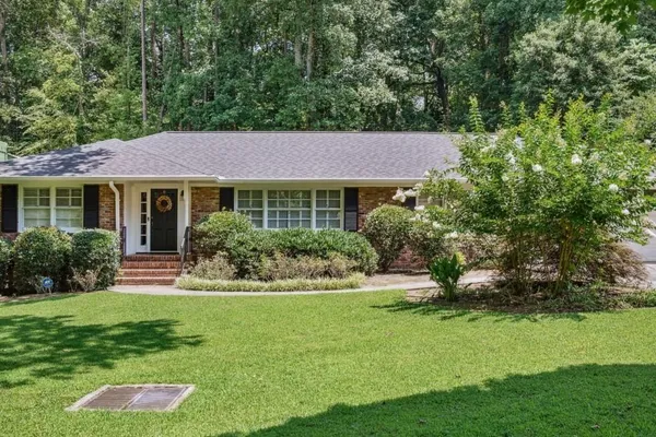 a front view of a house with a yard table and chairs
