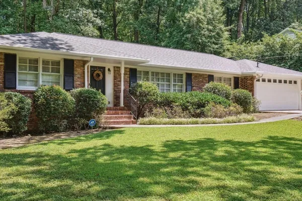 a view of a house with a garden and plants