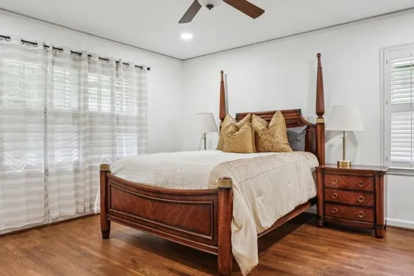 a bed sitting in a bedroom next to a window
