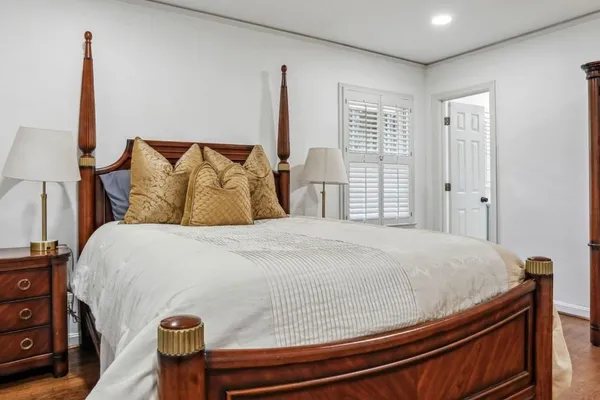 a bedroom with a bed and a night stand