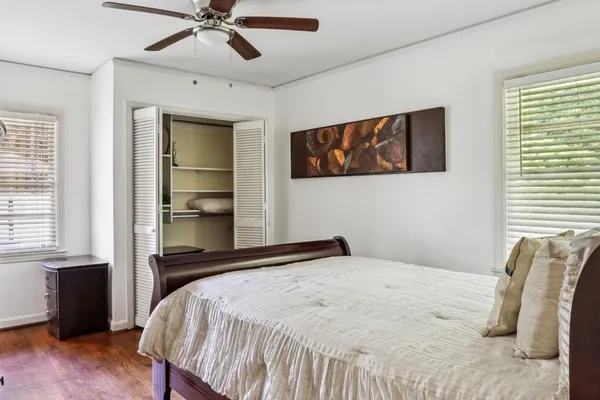 a bedroom with a bed and a window