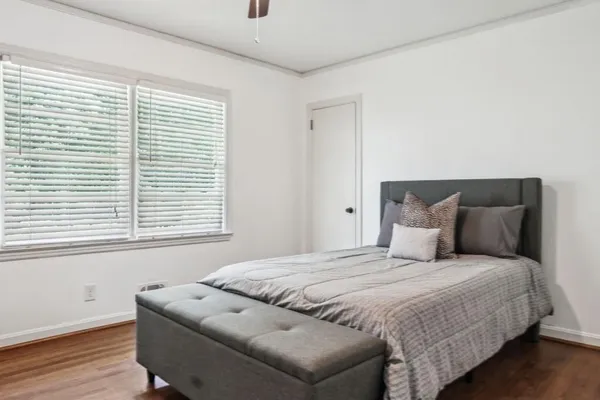 a bedroom with a bed and a window