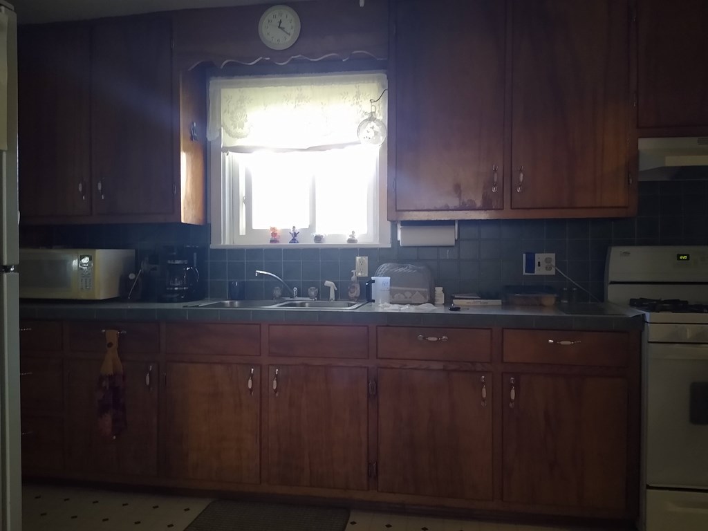 492 Chestnut Street Rimersburg, PA 16248 - Photo 3 of 15 a kitchen with granite countertop a sink cabinets and window