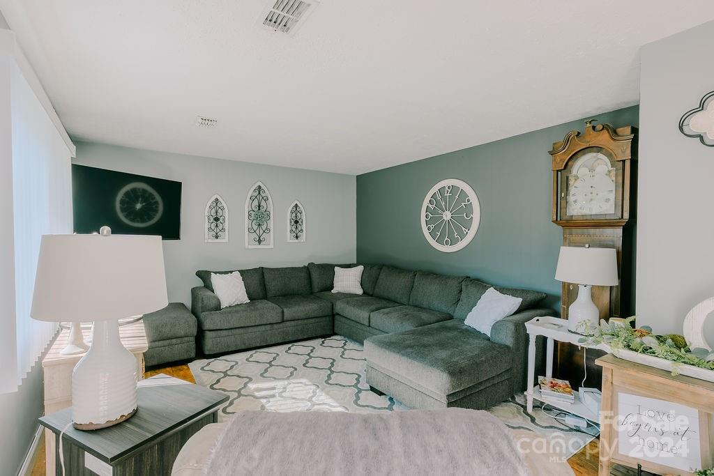 162 Pine Ridge Trail Pinnacle, NC 27043 - Photo 12 of 41 a living room with furniture a clock and a view of kitchen