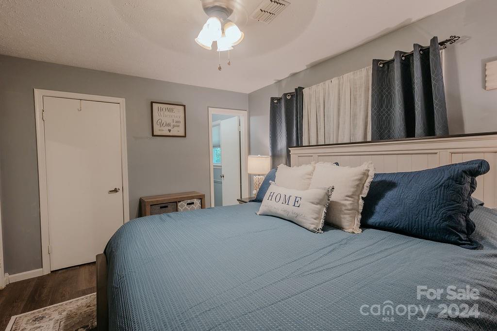 162 Pine Ridge Trail Pinnacle, NC 27043 - Photo 20 of 41 a bedroom with a large bed and a chandelier