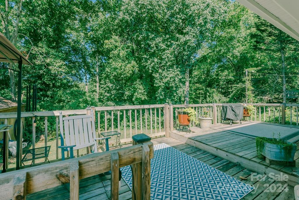 162 Pine Ridge Trail Pinnacle, NC 27043 - Photo 36 of 41 a view of a deck with chairs and wooden fence