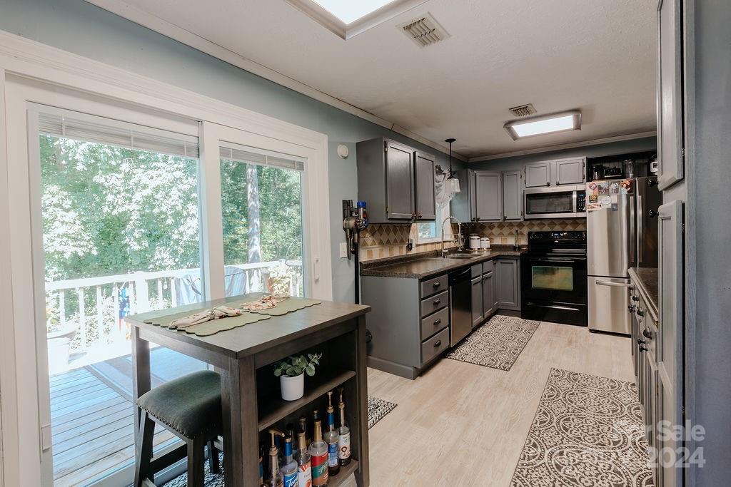 162 Pine Ridge Trail Pinnacle, NC 27043 - Photo 7 of 41 a kitchen with a table chairs refrigerator and cabinets
