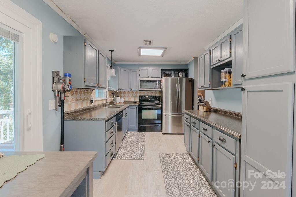 162 Pine Ridge Trail Pinnacle, NC 27043 - Photo 10 of 41 a kitchen with stainless steel appliances granite countertop a refrigerator stove and oven