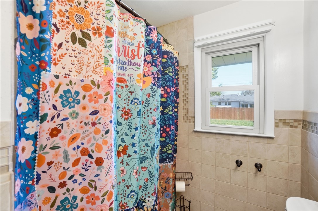 1325 Chelsea Road Troy, OH 45373 - Photo 24 of 42 This bathroom features a bright window and tiled walls, creating a welcoming and comfortable atmosphere.