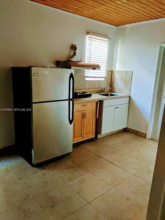 a kitchen with stainless steel appliances a refrigerator sink and cabinets