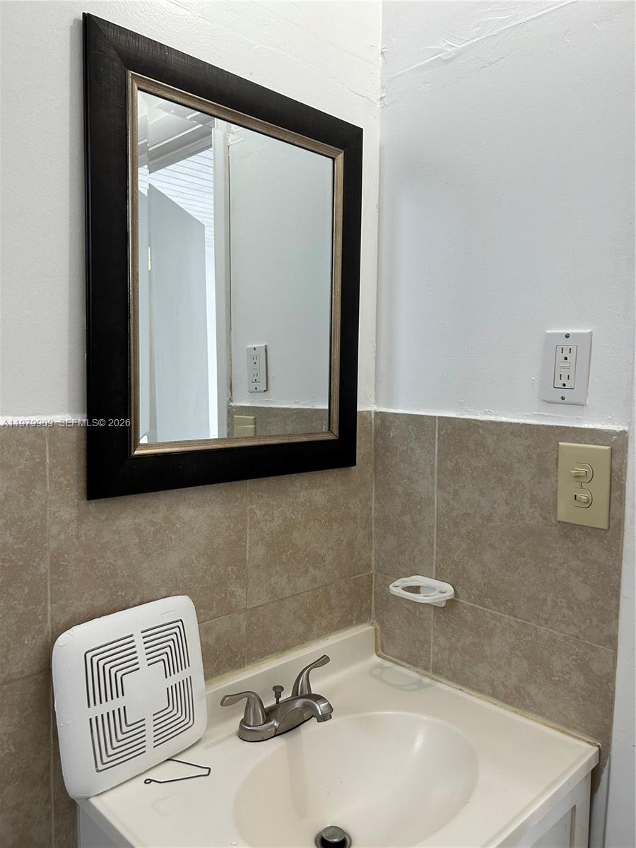 13351 Southwest 258th Terrace Homestead, FL 33032 - Photo 9 of 11 a bathroom with a sink a mirror and a toilet
