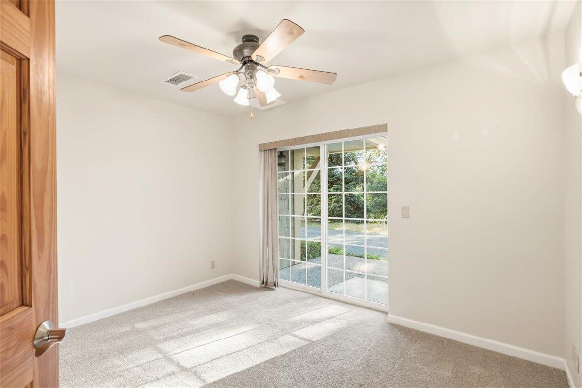 12531 Lowhills Road Nevada City, CA 95959 - Photo 52 of 92 an empty room with windows and fan