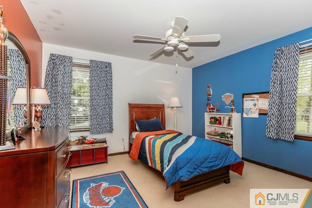 26 Fox Hill Road Edison, NJ 08820 - Photo 17 of 23 a bedroom with a bed and wooden floor