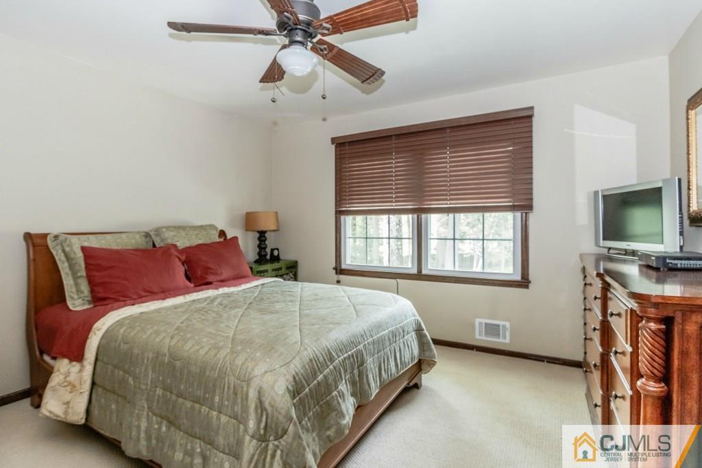 26 Fox Hill Road Edison, NJ 08820 - Photo 18 of 23 a bedroom with a bed and a flat screen tv