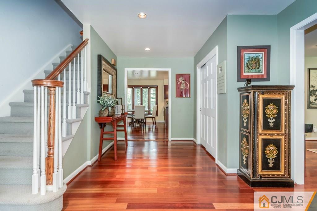 26 Fox Hill Road Edison, NJ 08820 - Photo 3 of 23 a view of a hallway with wooden floor and dining room view
