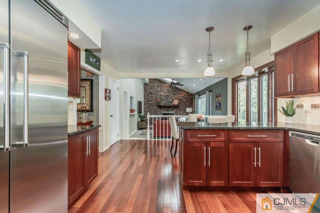 26 Fox Hill Road Edison, NJ 08820 - Photo 9 of 23 a kitchen with stainless steel appliances granite countertop a refrigerator a sink dishwasher a stove and white countertops with wooden floor