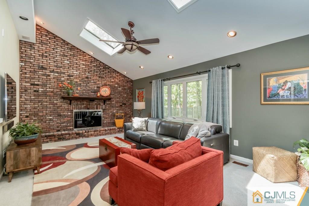 26 Fox Hill Road Edison, NJ 08820 - Photo 10 of 23 a living room with furniture and a fireplace