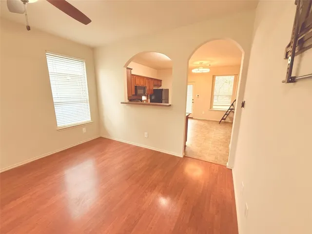 a view of a room with wooden floor and a window