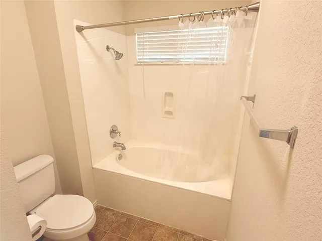 a bathroom with a toilet a sink and a bathtub