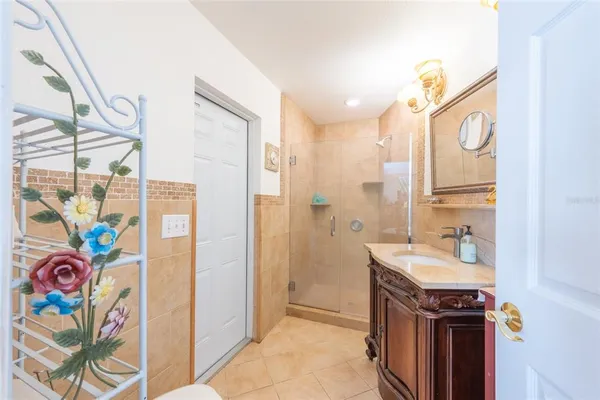 a bathroom with a sink a mirror and a shower