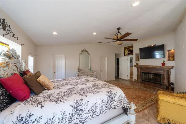 a spacious bedroom with a bed and a television