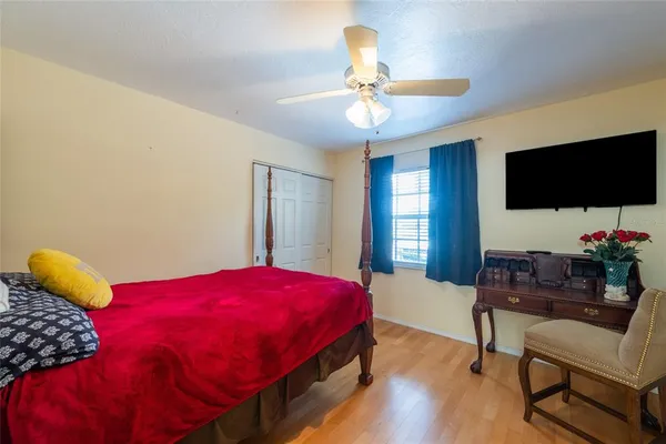 a bedroom with a bed and a flat screen tv