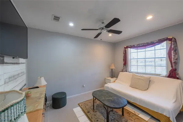 a view of a livingroom with furniture and a window