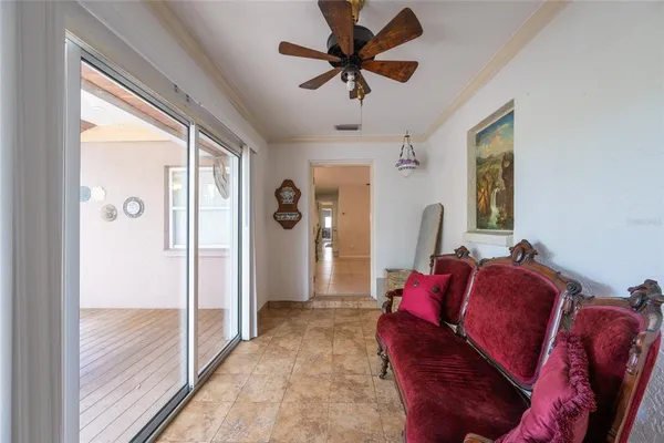 a living room with furniture and a ceiling fan