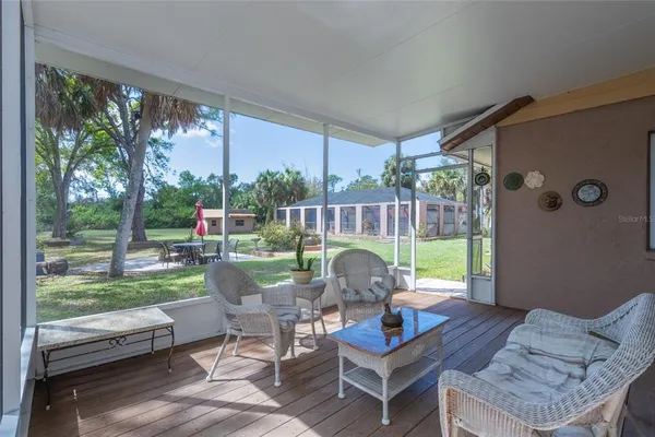 a view of a patio with a dining table and chairs