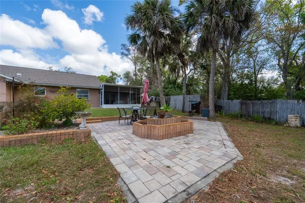 a view of a house with backyard and sitting area