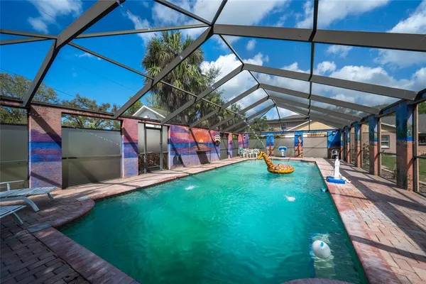 a view of a backyard with table and chairs with wooden floor and fence