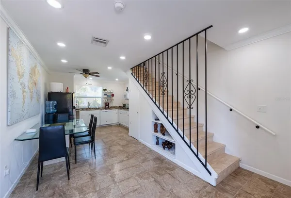a kitchen with a table chairs stove and cabinets