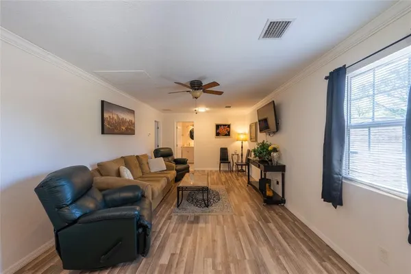 a bedroom with a bed couch and window