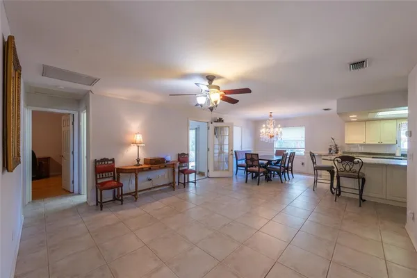 a view of a dining room with furniture and chandelier