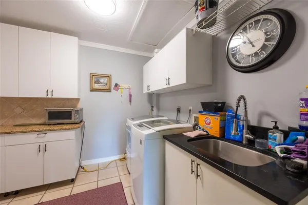 a view of kitchen with microwave and cabinets