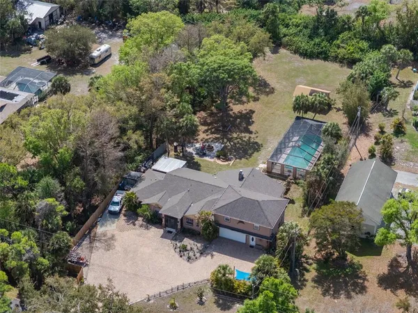 an aerial view of a house with a yard