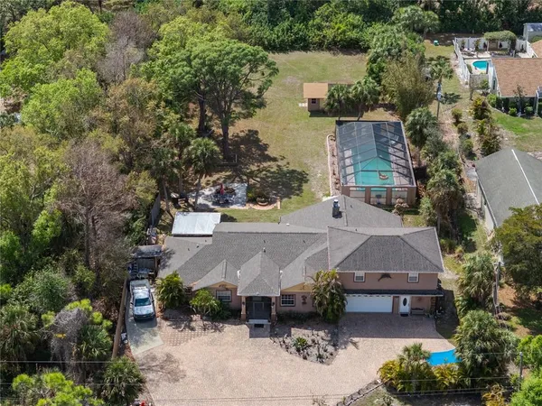 an aerial view of a house with outdoor space