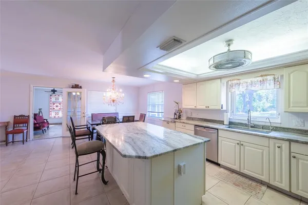 a kitchen with center island table and chairs in it