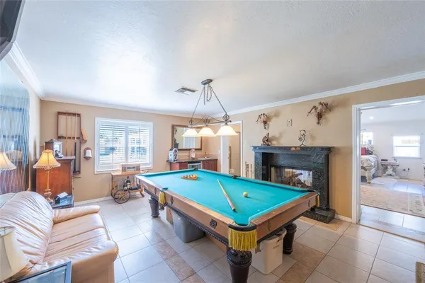 a living room with pool table and a couch